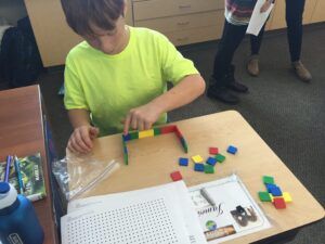 student using manipulatives